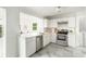 Modern kitchen featuring stainless steel appliances, white cabinets, and sleek countertops at 2315 Shamrock Dr, Decatur, GA 30032