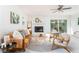 Bright living room features white brick fireplace, modern furnishings, and plenty of natural light at 2315 Shamrock Dr, Decatur, GA 30032