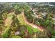 Aerial view of the house and neighborhood with golf course access surrounded by lush greenery at 3997 Ironhill Ln, Woodstock, GA 30189