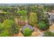 Overhead view of the home, situated in a community with a canopy of trees and manicured lawns at 3997 Ironhill Ln, Woodstock, GA 30189