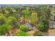 Stunning aerial view of a residence with mature trees and lush landscaping at 3997 Ironhill Ln, Woodstock, GA 30189