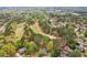 Aerial view showing the property and community near a beautiful, lush, green golf course at 3997 Ironhill Ln, Woodstock, GA 30189
