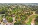 The aerial shot showcases the home in a tree-lined neighborhood with lush golf course views at 3997 Ironhill Ln, Woodstock, GA 30189