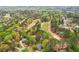 An aerial view showcases the property adjacent to a lush golf course with tree-lined streets at 3997 Ironhill Ln, Woodstock, GA 30189