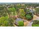 Beautiful overhead view showcases an attractive home surrounded by a dense woodland area at 3997 Ironhill Ln, Woodstock, GA 30189