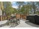 Back deck featuring an outdoor dining set and grill at 3997 Ironhill Ln, Woodstock, GA 30189