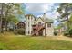 Backyard featuring a wooden deck, screened porch, and lush greenery at 3997 Ironhill Ln, Woodstock, GA 30189