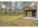 Backyard featuring a deck, patio, and expansive lawn at 3997 Ironhill Ln, Woodstock, GA 30189