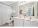 Bright bathroom with double vanity, neutral walls, and a shower with patterned curtain at 3997 Ironhill Ln, Woodstock, GA 30189