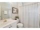 Cozy bathroom featuring a sink, toilet, shower with curtain, and wall art at 3997 Ironhill Ln, Woodstock, GA 30189