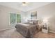 Inviting bedroom with a large window, stylish bedding, and elegant bedside table decor at 3997 Ironhill Ln, Woodstock, GA 30189
