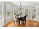 Breakfast nook with hardwood floors, black table and neutral upholstered chairs, with natural light at 3997 Ironhill Ln, Woodstock, GA 30189