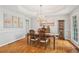 Dining room featuring trey ceiling, hardwood floors, and a vintage-style china cabinet at 3997 Ironhill Ln, Woodstock, GA 30189