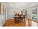 Bright dining room with hardwood floors, chandelier, and large windows offering natural light at 3997 Ironhill Ln, Woodstock, GA 30189