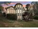 Charming home featuring unique architectural details, a screened porch, a deck with stairs, and lush landscaping at 3997 Ironhill Ln, Woodstock, GA 30189