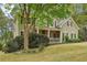 Charming home with stone accents on front porch and manicured landscaping at 3997 Ironhill Ln, Woodstock, GA 30189