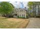 Attractive home featuring an attached garage, stone accents and a lush, green lawn at 3997 Ironhill Ln, Woodstock, GA 30189