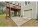 Exterior view of a home featuring a back deck above a patio and a two car garage at 3997 Ironhill Ln, Woodstock, GA 30189