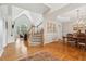 Bright entryway with hardwood floors, staircase, and views into the dining and living areas at 3997 Ironhill Ln, Woodstock, GA 30189