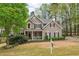 Inviting two-story home featuring a landscaped front yard and covered porch at 3997 Ironhill Ln, Woodstock, GA 30189