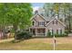 Inviting two-story home boasting a landscaped front yard and covered porch at 3997 Ironhill Ln, Woodstock, GA 30189