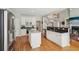 Modern kitchen with island, granite countertops, stainless steel appliances, and hardwood flooring at 3997 Ironhill Ln, Woodstock, GA 30189