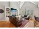Bright living room with high ceilings, built-in shelving, fireplace and oversized windows at 3997 Ironhill Ln, Woodstock, GA 30189