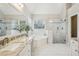 A stunning bathroom featuring a corner soaking tub, glass shower, and granite-topped vanity at 3997 Ironhill Ln, Woodstock, GA 30189