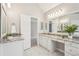 A bright bathroom with double sinks, a marble countertop, and a large mirror with accent lights at 3997 Ironhill Ln, Woodstock, GA 30189