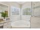 A luxurious bathroom with a soaking tub and a seamless glass shower with marble tile at 3997 Ironhill Ln, Woodstock, GA 30189