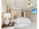 A bright main bedroom featuring a tray ceiling, ceiling fan, and decorative wall art at 3997 Ironhill Ln, Woodstock, GA 30189