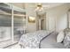 Bedroom featuring fan lighting, a bed with a patterned comforter, an entertainment unit, and closet at 3997 Ironhill Ln, Woodstock, GA 30189