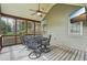 Screened-in porch with a ceiling fan and a mounted television at 3997 Ironhill Ln, Woodstock, GA 30189