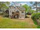 The rear exterior showcases a spacious yard, deck access, and lower level entry to the home at 3997 Ironhill Ln, Woodstock, GA 30189