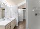Bathroom showcasing a vanity, mirror, and tiled shower stall with laminate flooring at 5666 Bob White Nw Cir, Lilburn, GA 30047