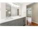 Bathroom with a double sink vanity, modern lighting, and ample counter space at 5666 Bob White Nw Cir, Lilburn, GA 30047