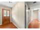Foyer features hardwood floors, neutral walls, and solid front door with side glass panels at 5666 Bob White Nw Cir, Lilburn, GA 30047