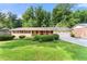 Charming single-story home with brick accents, attached garage, and a beautifully maintained lawn at 5666 Bob White Nw Cir, Lilburn, GA 30047