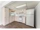 Cozy kitchen with light-colored cabinetry, laminate flooring, and standard appliances at 5666 Bob White Nw Cir, Lilburn, GA 30047