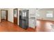 Kitchen view showcases stainless steel refrigerator, granite counters and white cabinets at 5666 Bob White Nw Cir, Lilburn, GA 30047