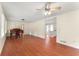 Spacious living room with gleaming hardwood floors, piano and direct access to the kitchen at 5666 Bob White Nw Cir, Lilburn, GA 30047