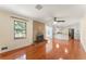 Open concept living room with brick fireplace, hardwood floors, and access to the kitchen at 5666 Bob White Nw Cir, Lilburn, GA 30047