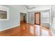 Open-concept room with hardwood flooring, natural light, and a connecting doorway at 5666 Bob White Nw Cir, Lilburn, GA 30047