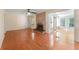 Spacious living room with hardwood floors, a brick fireplace, and natural light, offering a cozy atmosphere at 5666 Bob White Nw Cir, Lilburn, GA 30047