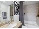 Cozy bathroom showcasing stylish decor and a shower-tub with decorative tile surround at 855 Peachtree Ne St # 3005, Atlanta, GA 30308