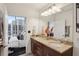 Bright bathroom with double sinks and a view through an open doorway to a bedroom at 855 Peachtree Ne St # 3005, Atlanta, GA 30308