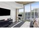 Bright bedroom featuring a sleek workspace, contemporary furniture, and scenic views at 855 Peachtree Ne St # 3005, Atlanta, GA 30308