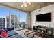 Bright living room features modern lighting, a TV, and floor to ceiling windows at 855 Peachtree Ne St # 3005, Atlanta, GA 30308