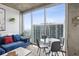 Stylish living room features floor to ceiling windows offering views of the city at 855 Peachtree Ne St # 3005, Atlanta, GA 30308