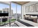 Tastefully furnished main bedroom features a desk and city views at 855 Peachtree Ne St # 3005, Atlanta, GA 30308